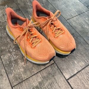 Hoka Orange Running Shoes with Yellow Accents
